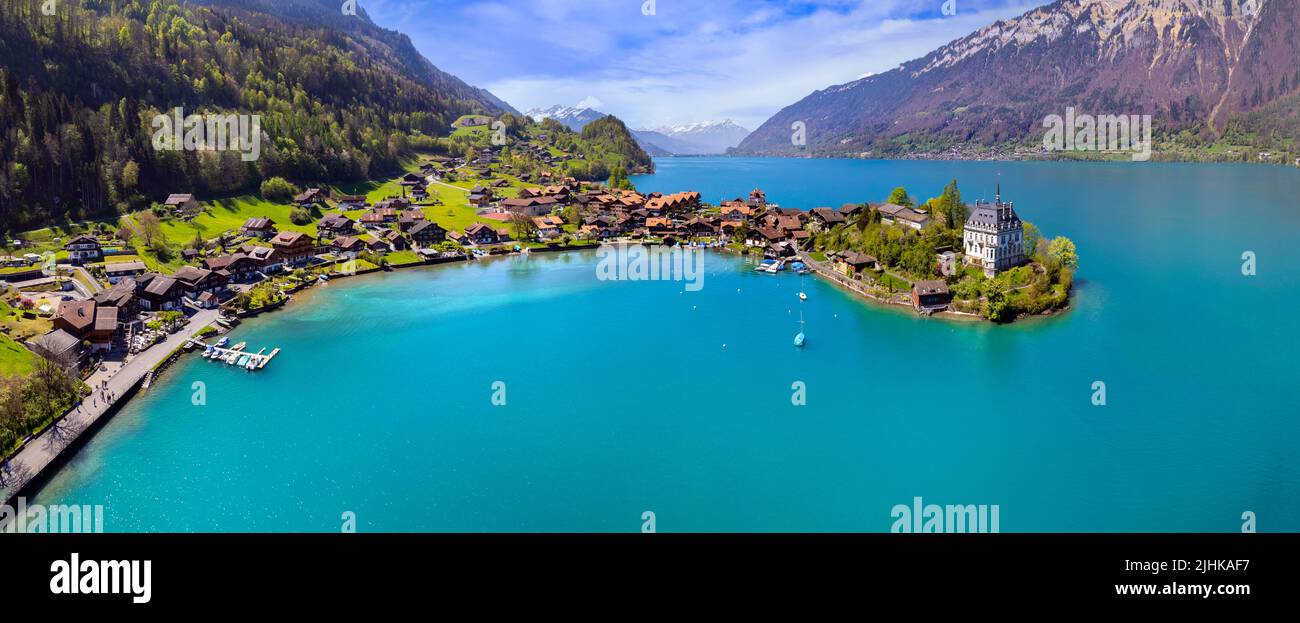 Stunning idyllic nature scenery of lake Brienz with turquoise waters. Switzerland, iseltwald village, Bern canton. village surrounded turquoise waters Stock Photo