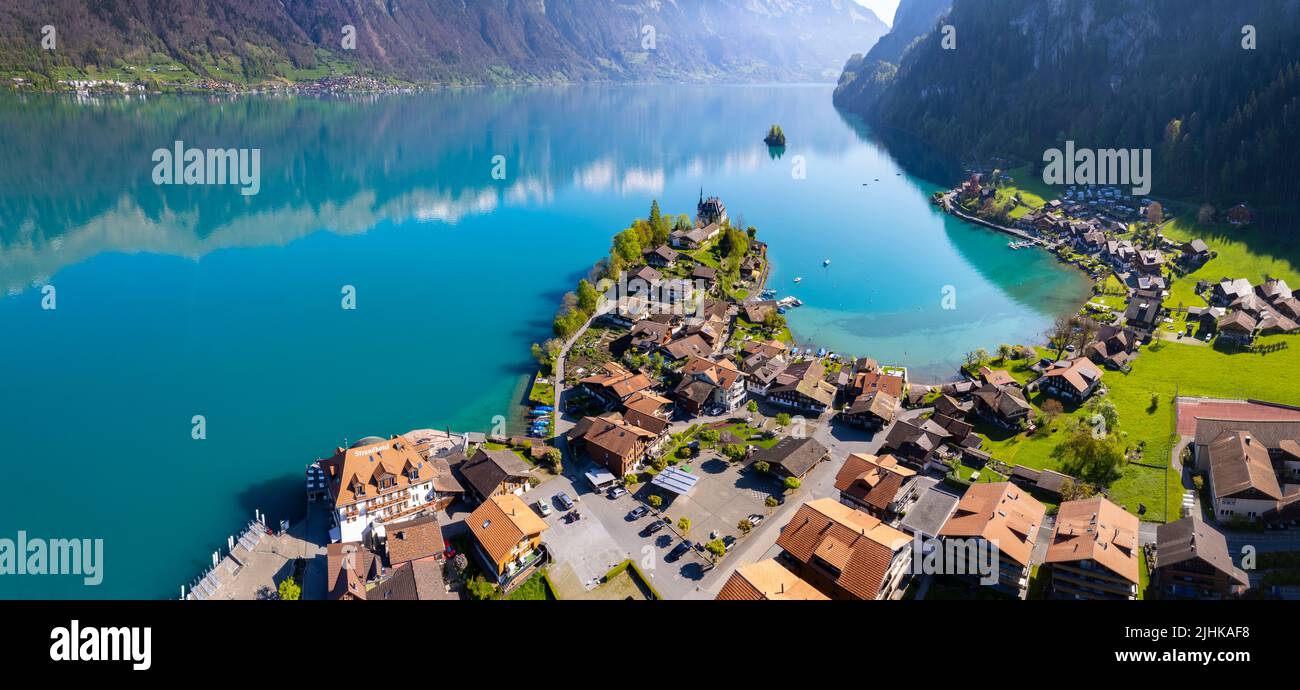 Stunning idyllic nature scenery of lake Brienz with turquoise waters. Switzerland, iseltwald village, Bern canton. village surrounded turquoise waters Stock Photo