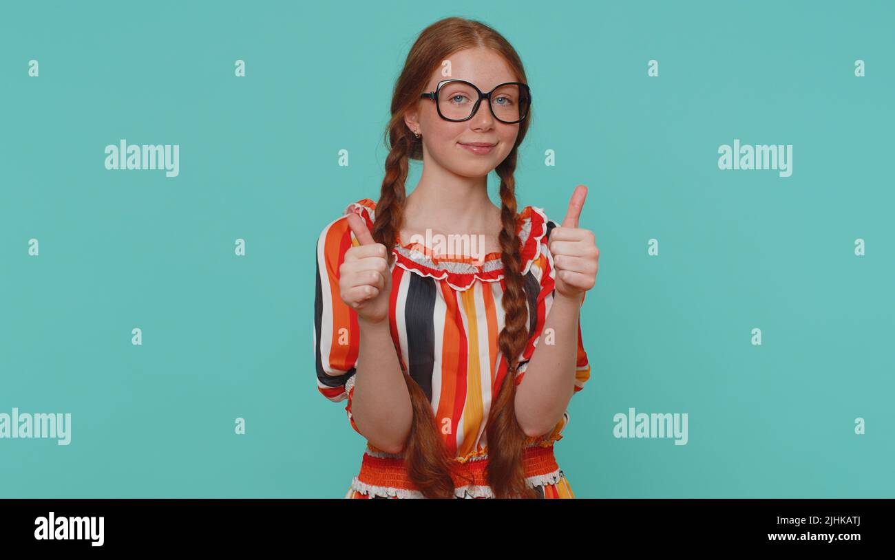 Great nice job. Cheerful positive happy girl in dress showing thumbs up