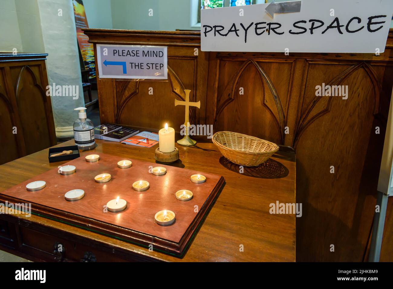 Candles and a cross at a proayer space within Down Cathedral (Church of Ireland), Downpatrick, County Down, Northern Ireland, United Kingdom, UK Stock Photo