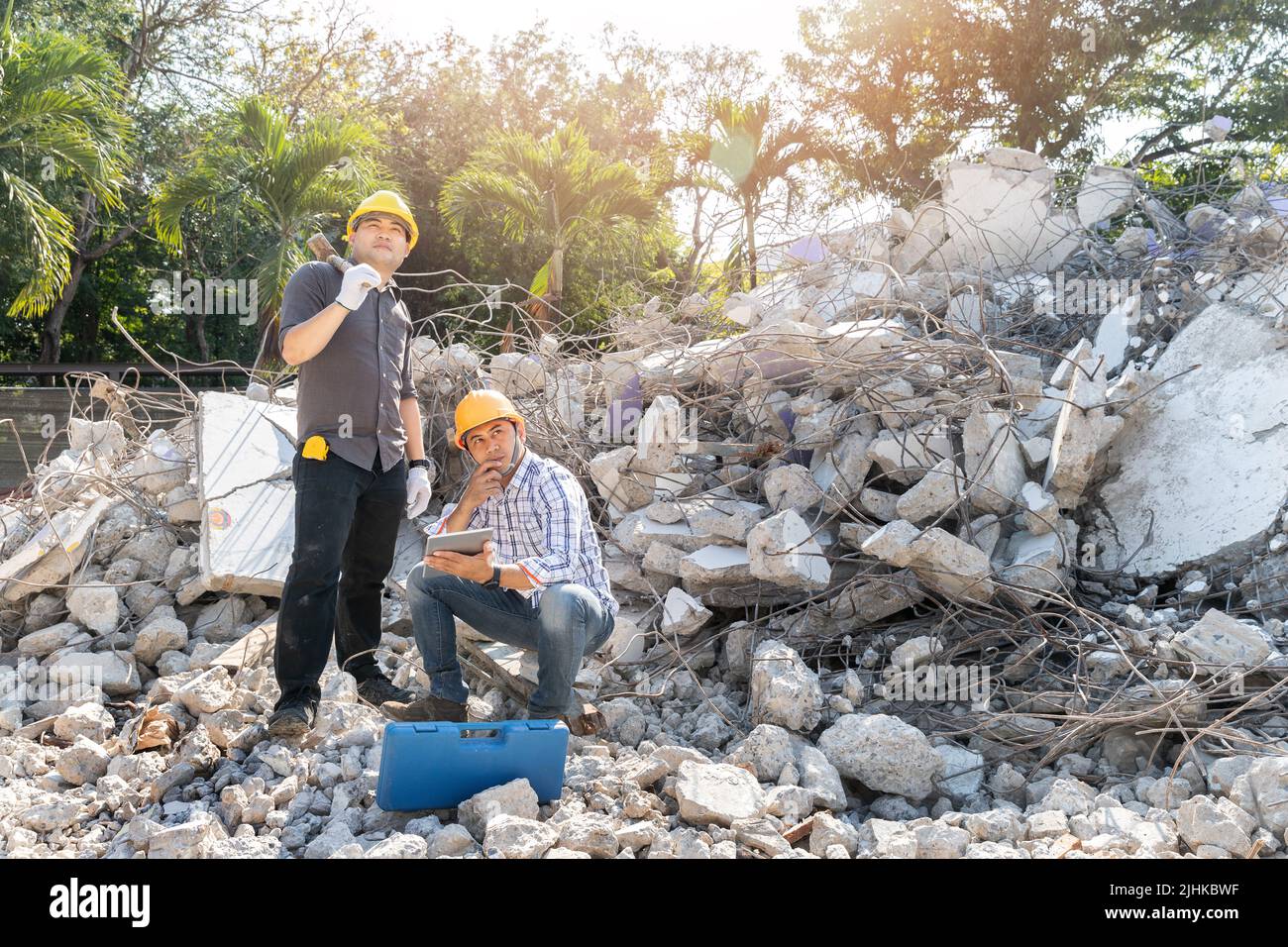 Demolition control supervisor and contractor using tablet to planning on demolish building. Stock Photo