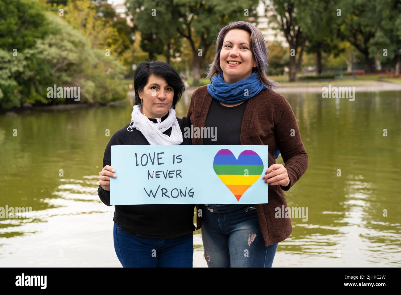 Love is never wrong. Cheerful queer couple holding a message supporting the LGBT community Stock Photo