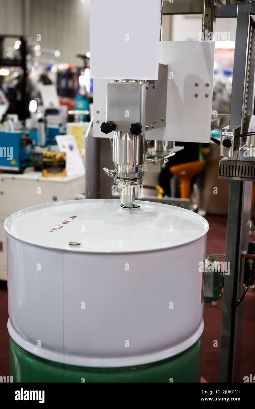 Automatic drum filling machine. Liquid barrel filler Stock Photo Alamy