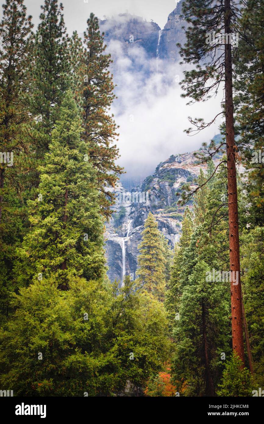 Upper and lower Yosemite falls cascade over the shear cliffs of Yosemite Valley in Yosemite National Park, California. Stock Photo