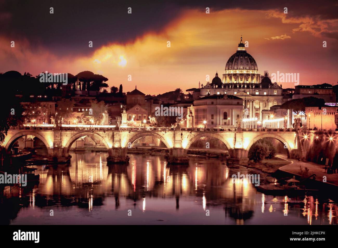 St. Peters Basilica rises above all along the banks of the Tiber River in Rome, Italy. Stock Photo