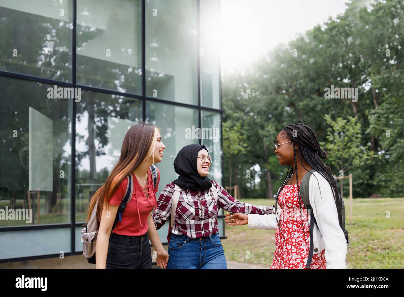 Three friends hanging out and enjoying their day at the campus Stock Photo