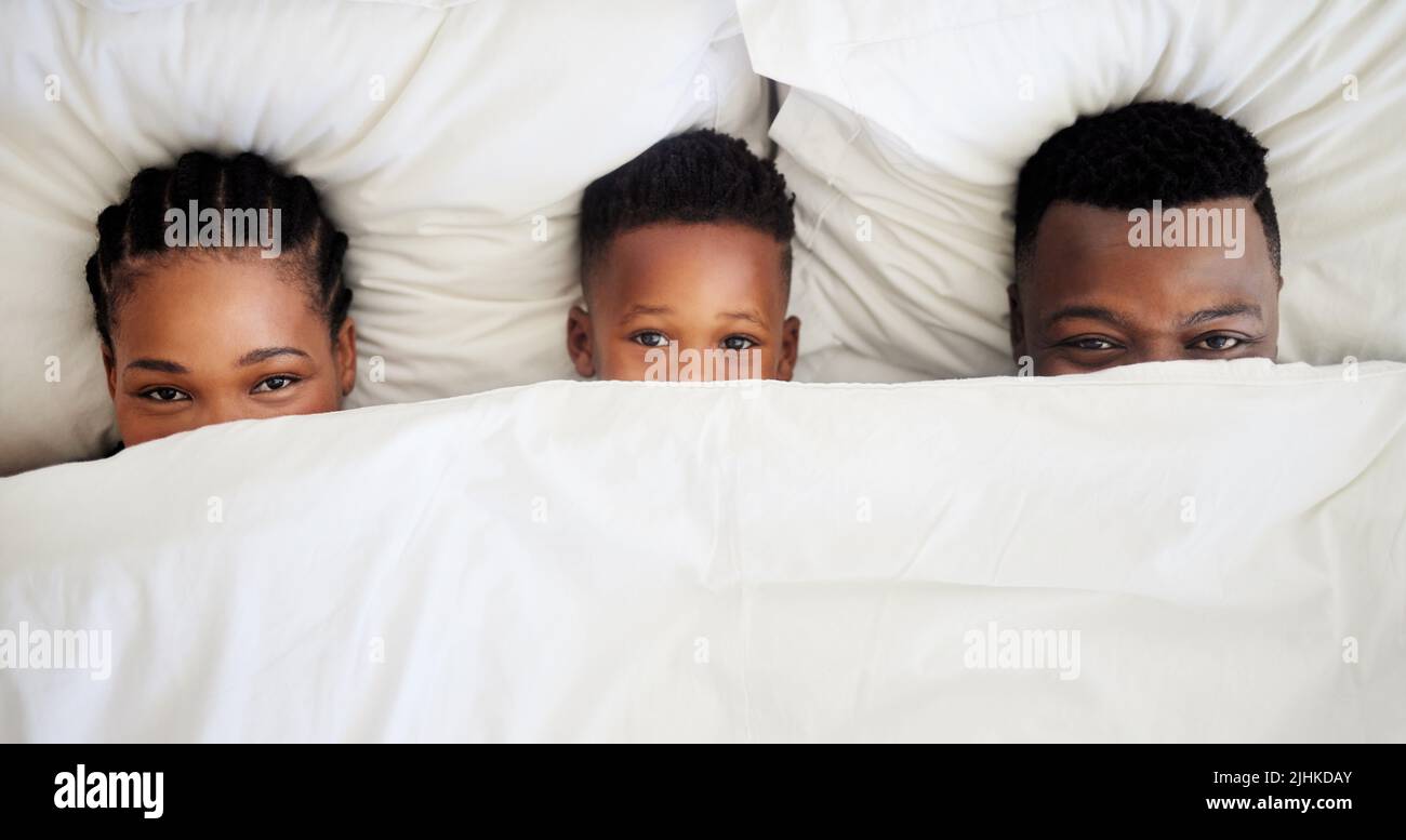 Were not ready to wake up just yet. High angle shot of a family peeking
