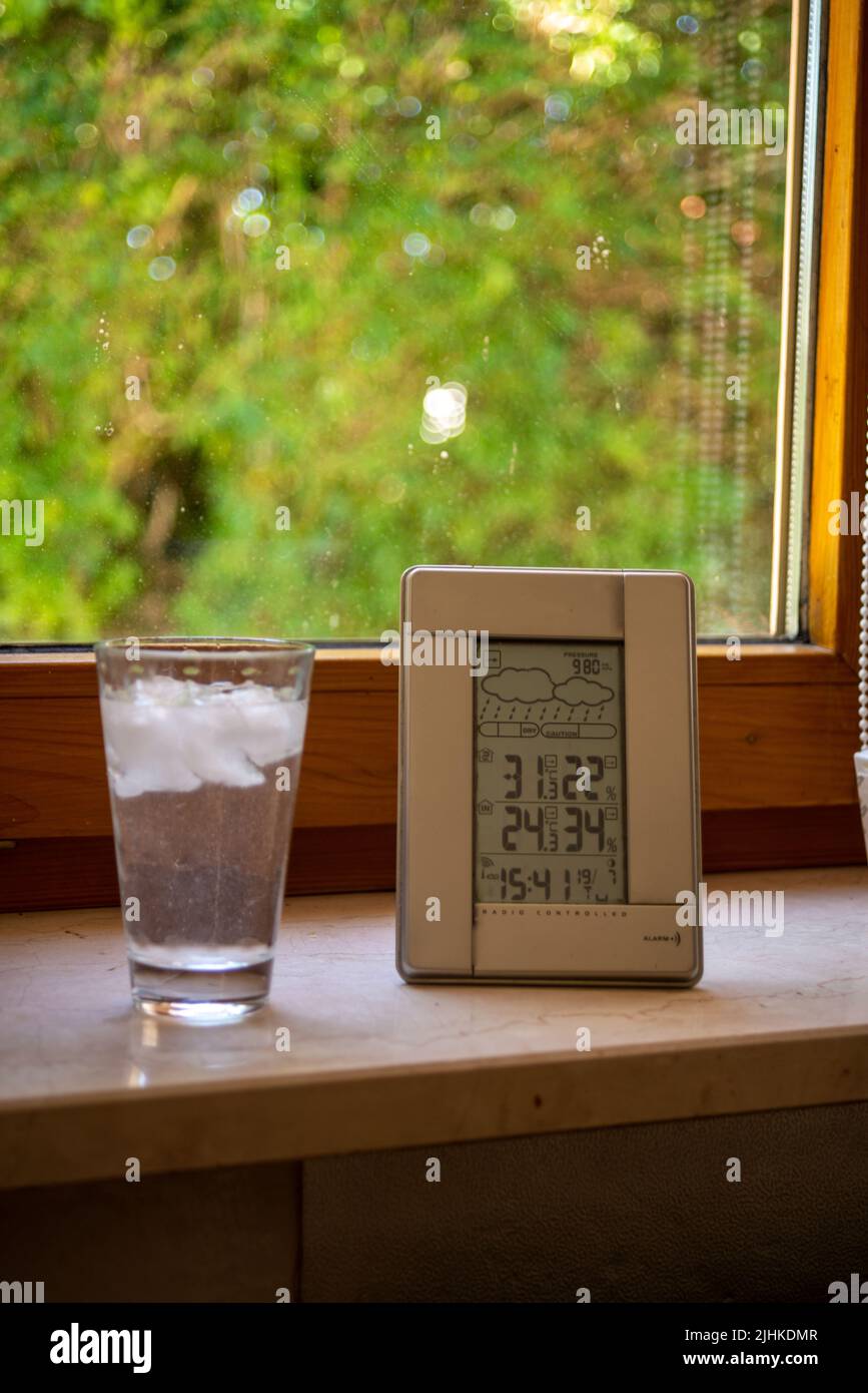 Weather station standing on a window sill indicating air temperature
