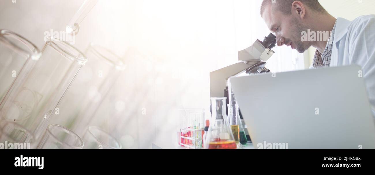 scientist search and test looking on microscope Stock Photo