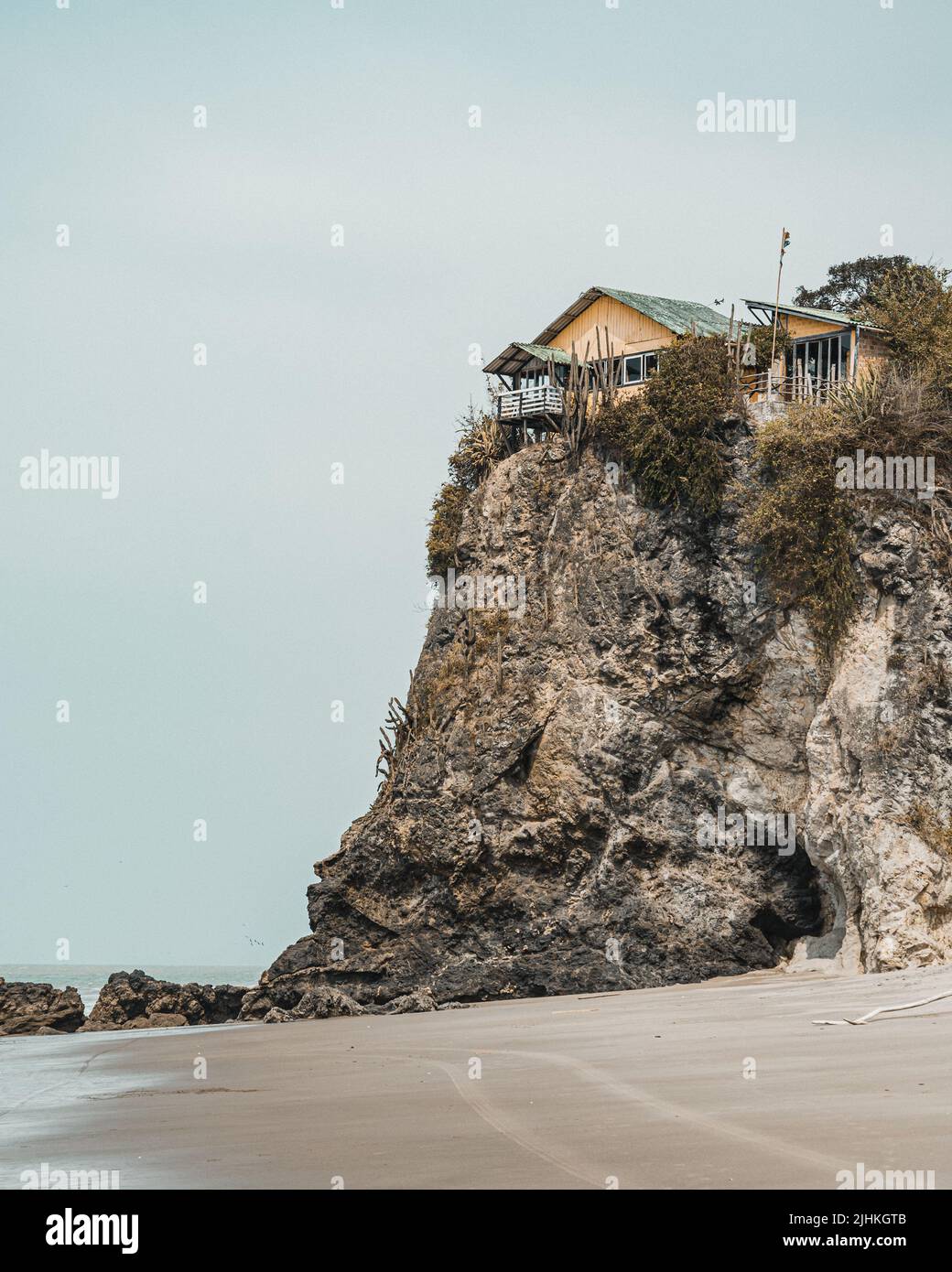 old yellow house on the edge of a cliff Stock Photo - Alamy