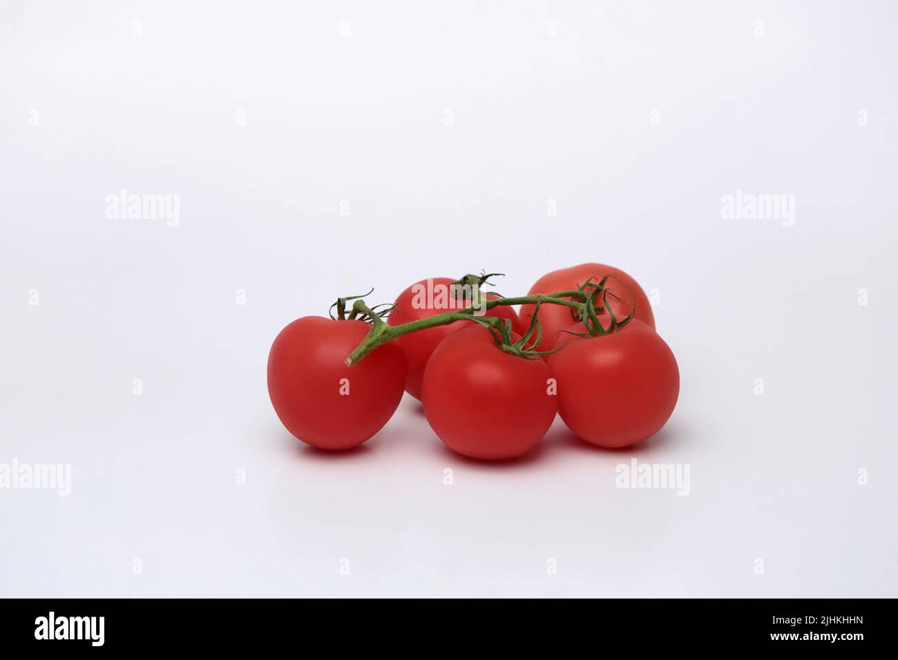 Cherry tomato bunch closeup isolated on white background Stock Photo ...