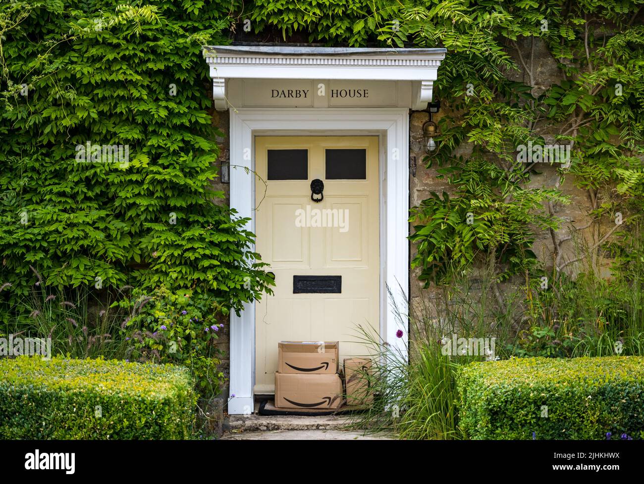 Amazon parcels left on a front doorstep of a period house, Dorset, England, UK Stock Photo