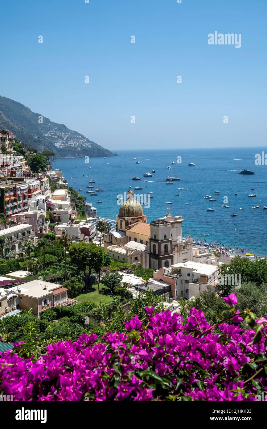 Positano is a cliffside village on southern Italy's Amalfi Coast. with The Church of St. Maria Assunta overlooking the coast Stock Photo