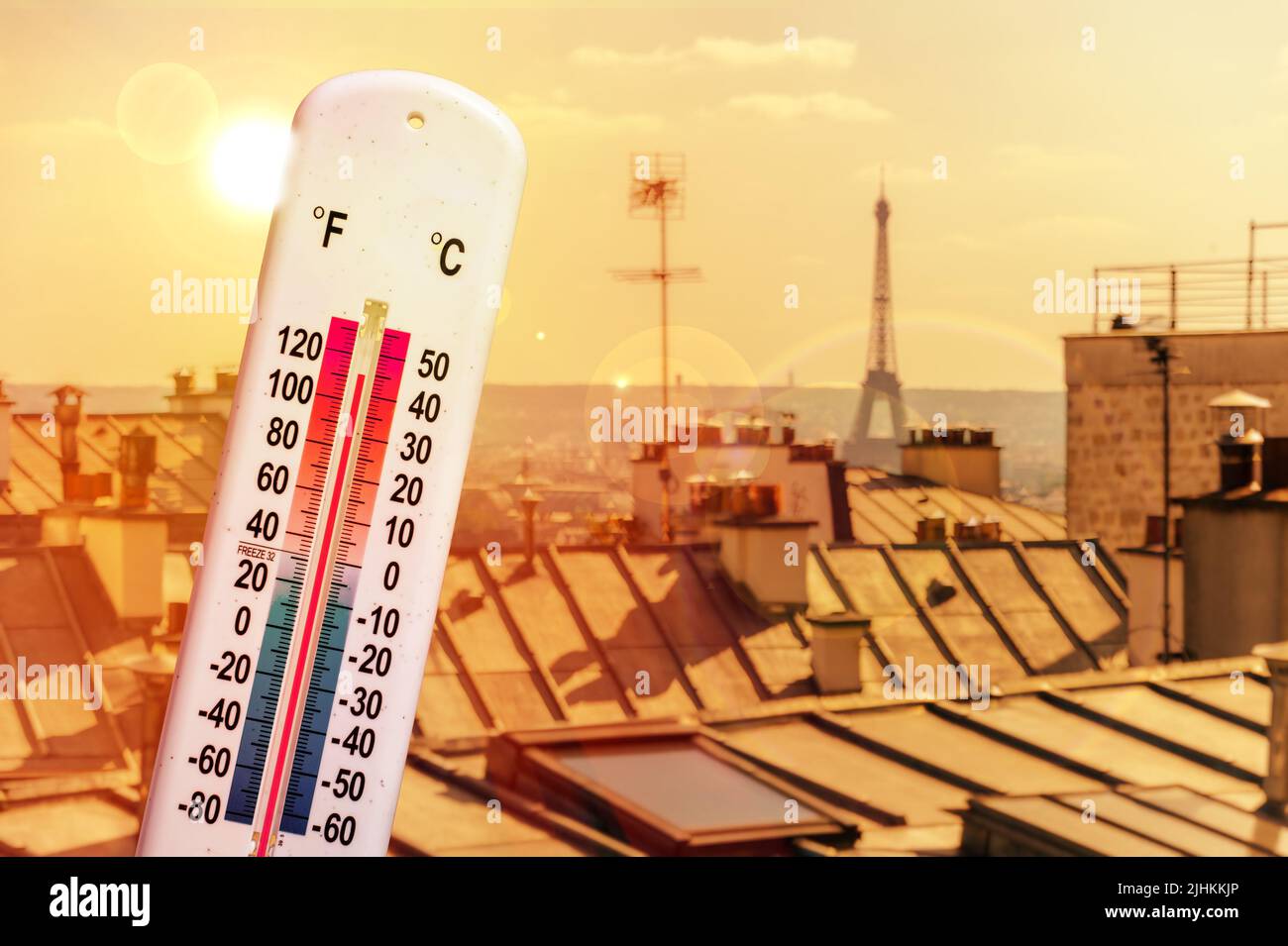 Thermometer in front of Paris skyline during heatwave in France Stock Photo