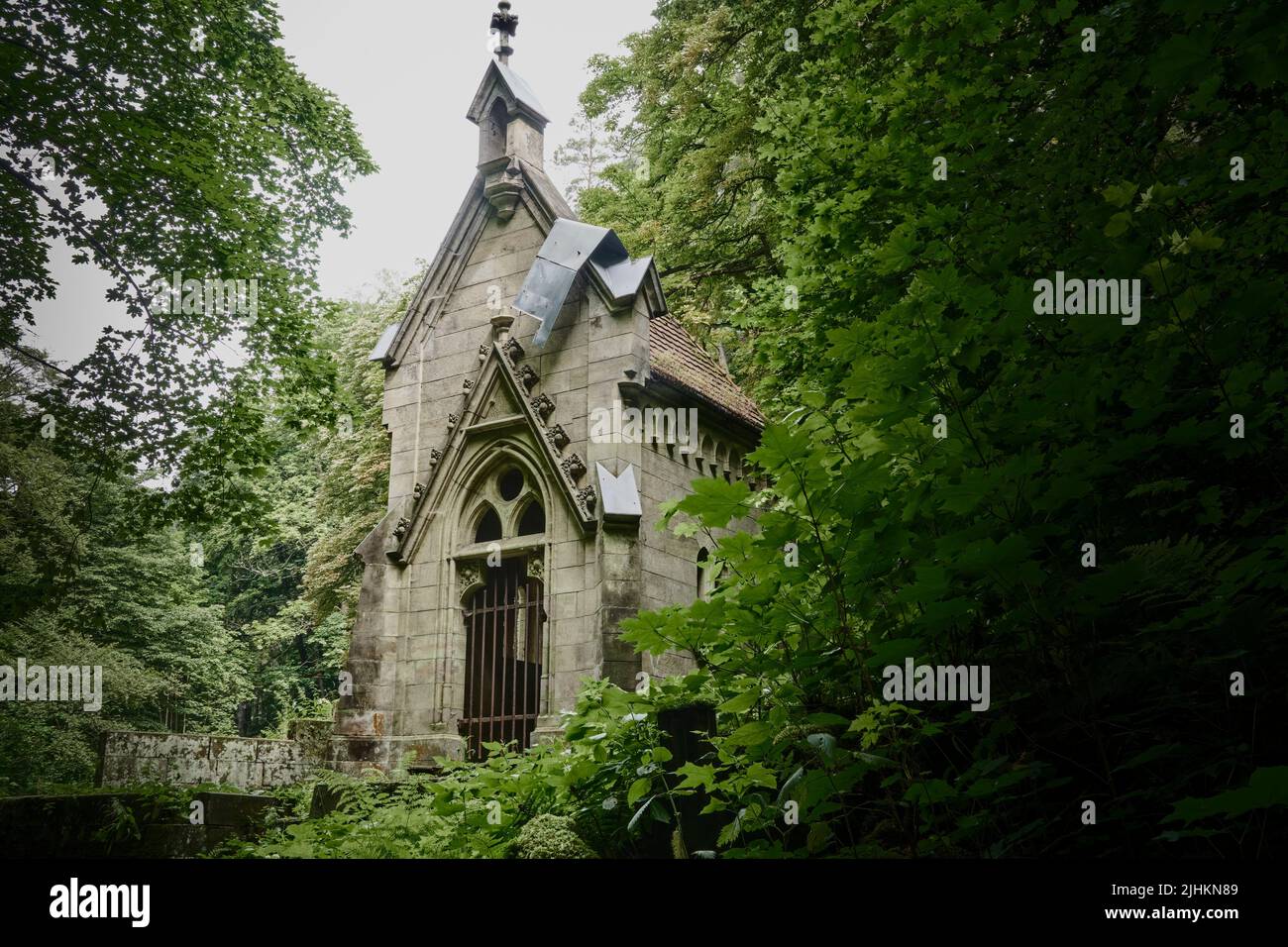 Abandoned cemetery chapel in a dense green forest Stock Photo Alamy