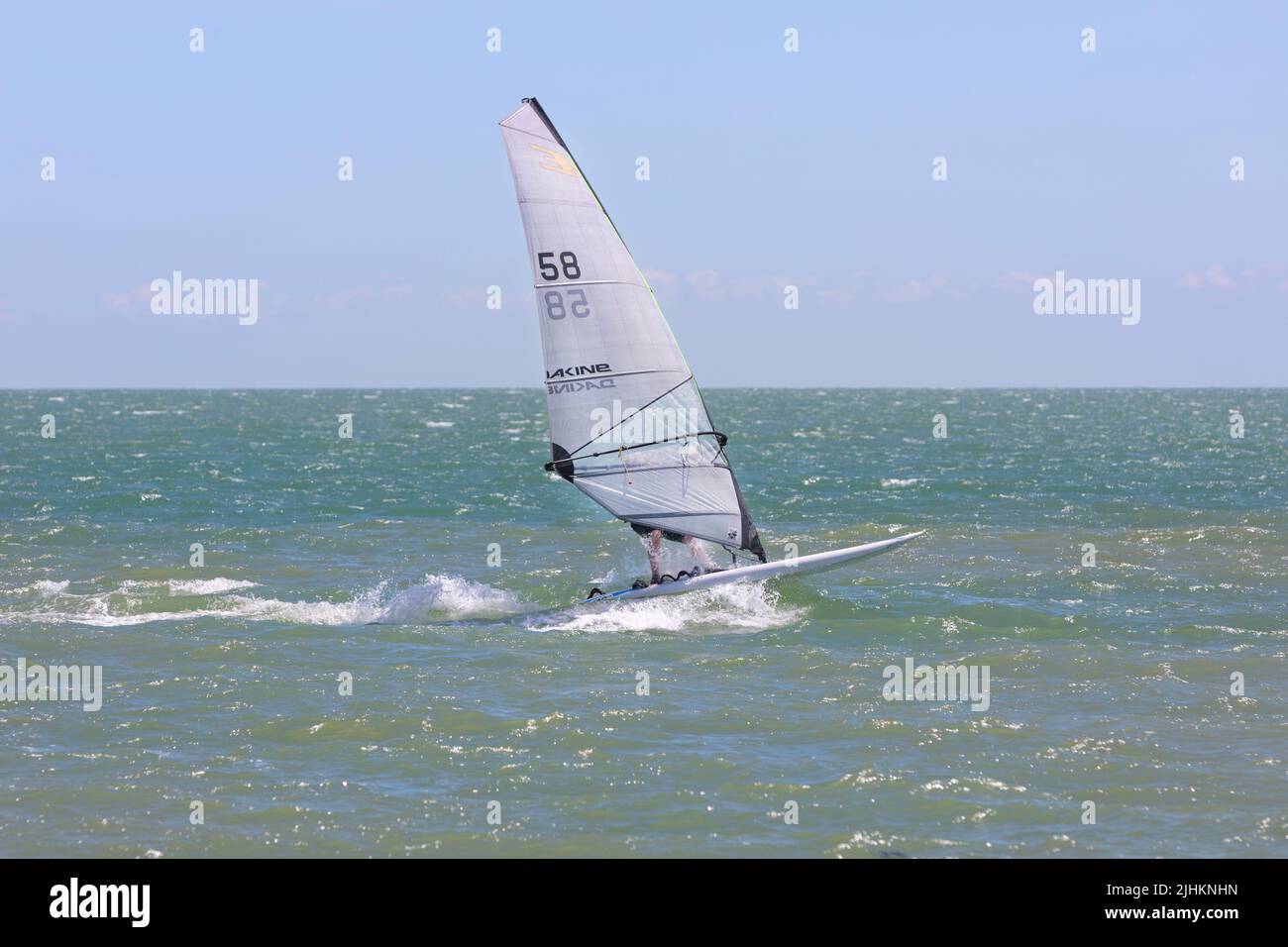 A wind surfer  in the English Channel off the beach at Hythe Stock Photo
