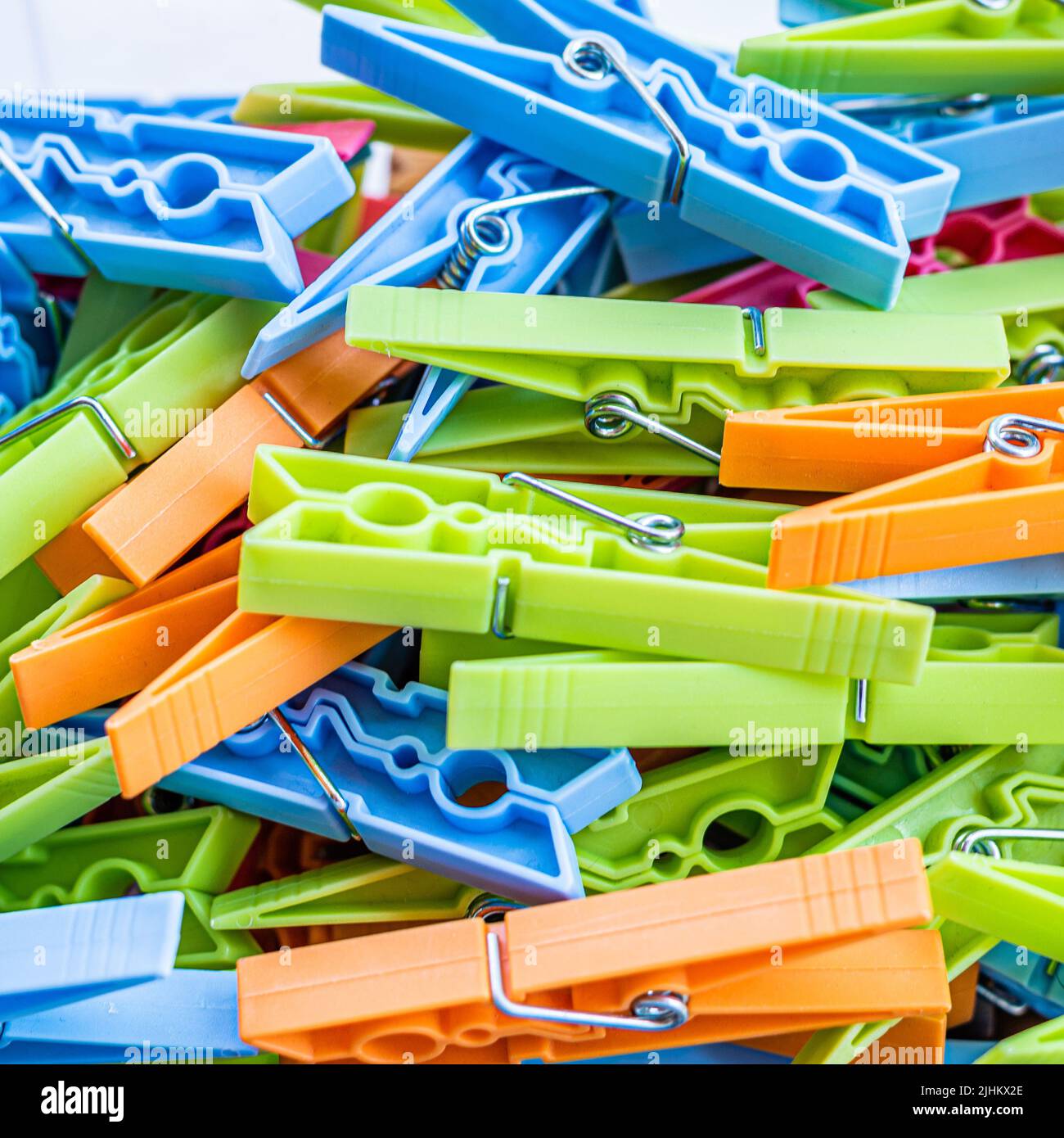 Pile coloured plastic clothes pegs hires stock photography and images