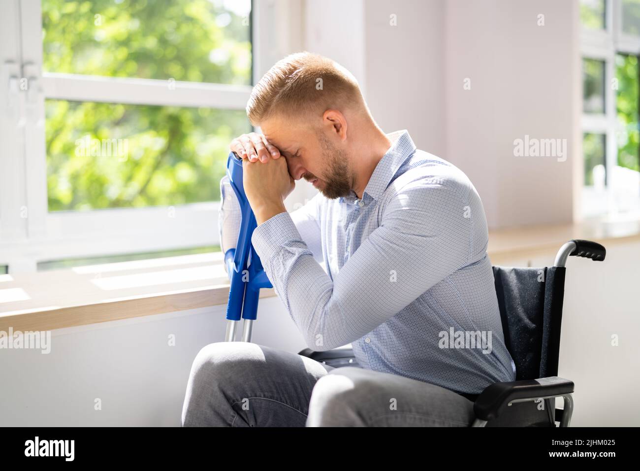 Disabled Man Difficulties. Big Accident Depression. Crutches And Wheelchair Stock Photo