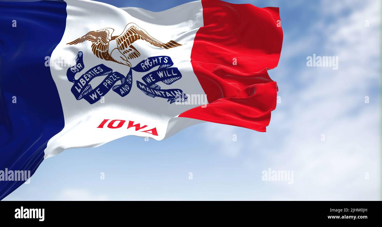 the flag of Iowa waving in the wind on a clear day. Iowa is a state located in the midwestern region of the United States. Democracy and independence. Stock Photo