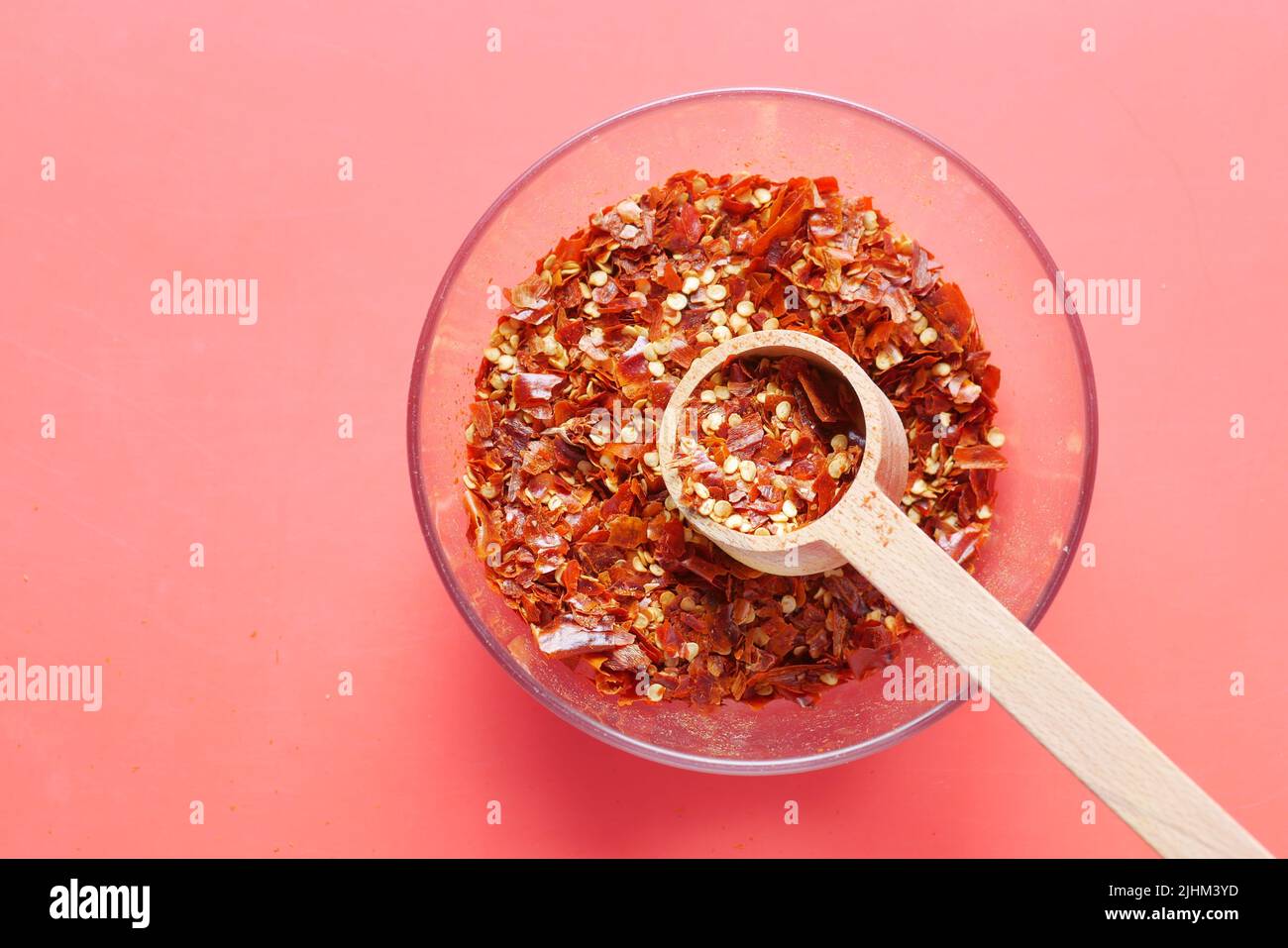 red chili pepper flakes on red background  Stock Photo