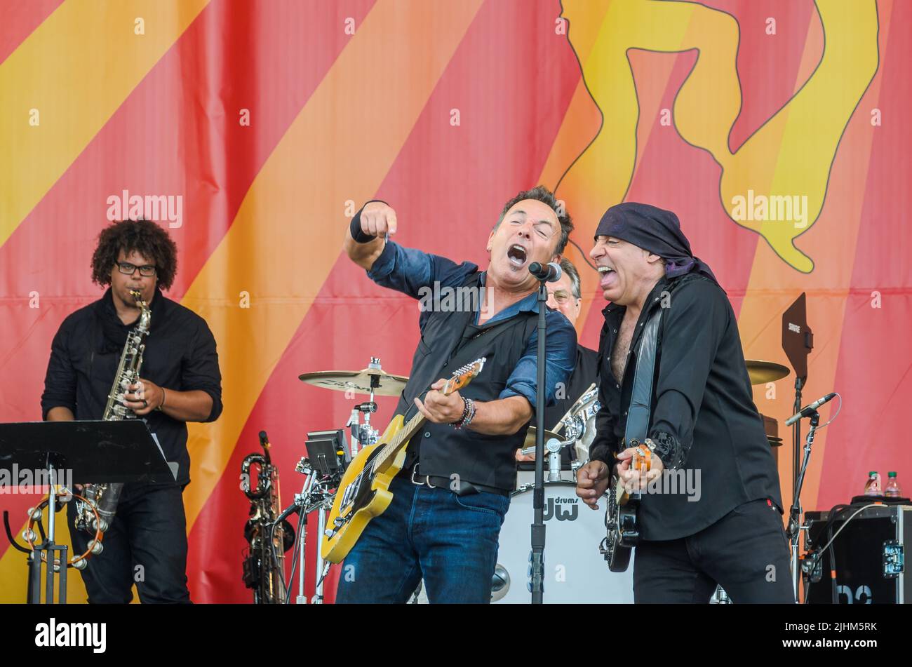 NEW ORLEANS, LA, USA - 04/29/12: Bruce Springsteen and Steve Van Zandt share microphone as Jake Clemons plays saxophone and Max Weinberg plays drums Stock Photo