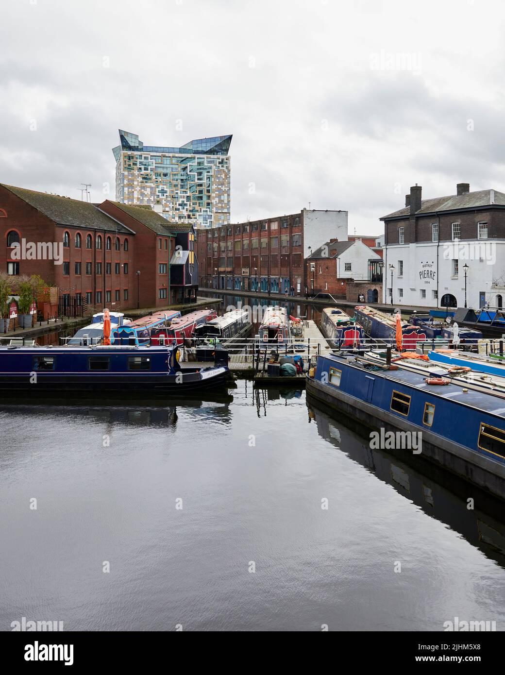 Birmingham, England with canal boats in the foreground and the Cube in the background Stock Photo