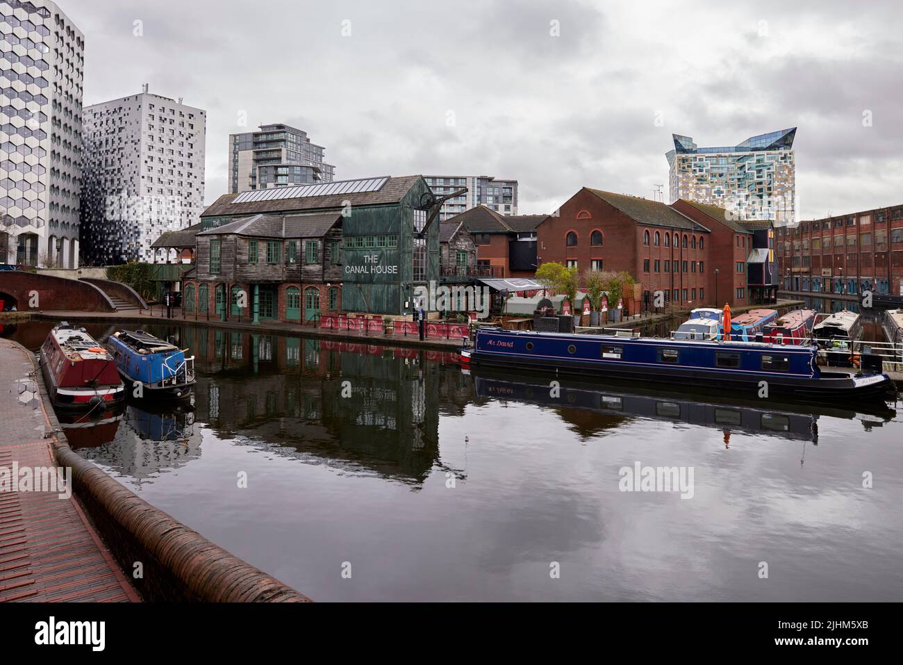 The Canal House in Birmingham, England with canal boats in the foreground and the Cube in the background Stock Photo