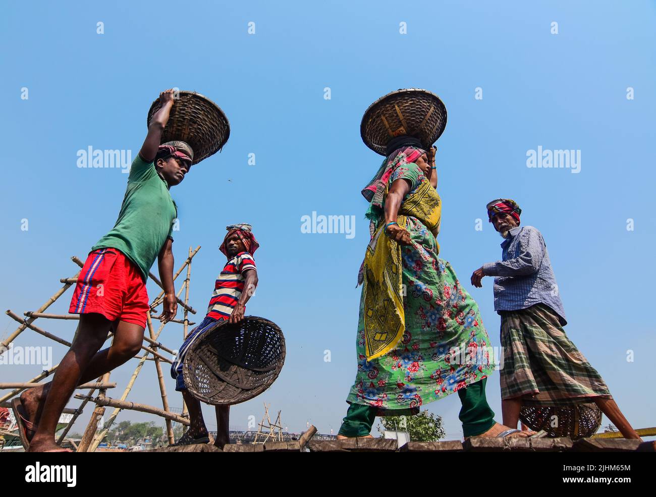 Women workers carrying baskets filled with coal on their head in the