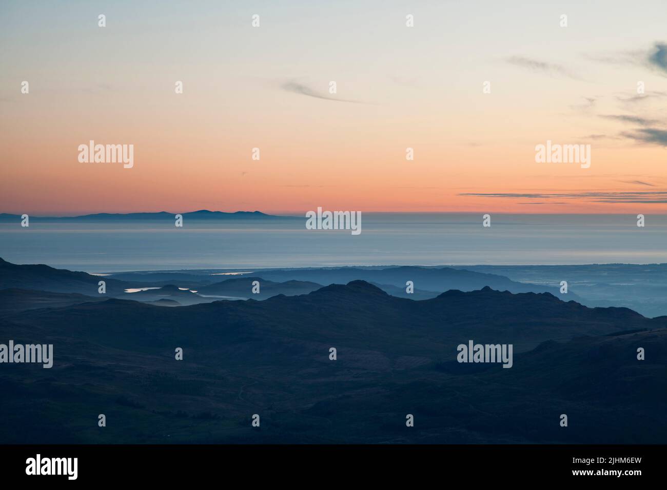 The Isle Of Man seen from the summit of Brim Fell in the English Lake District at dusk Stock Photo