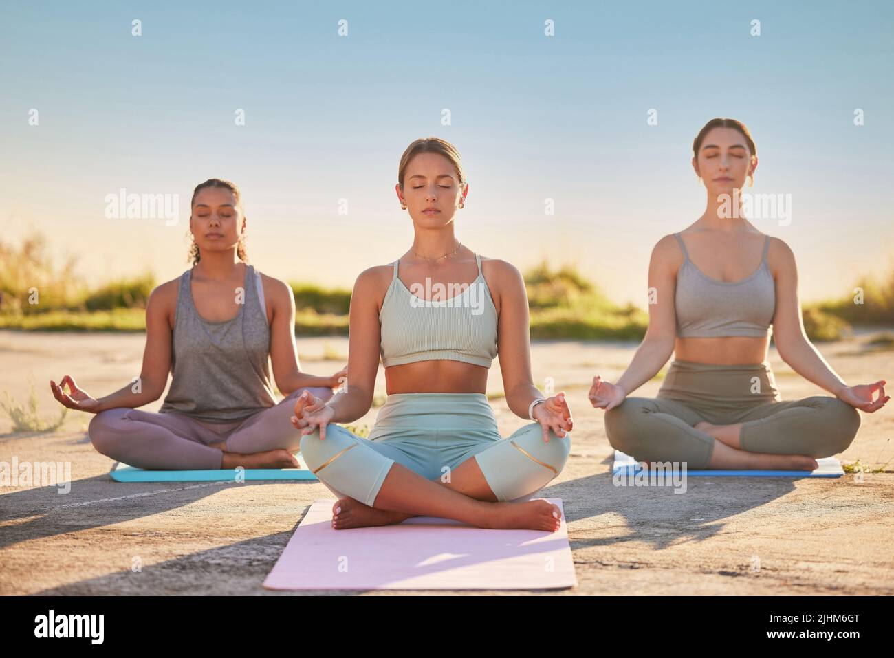 Picture of Full length yoga women meditating with legs crossed for outdoor ...