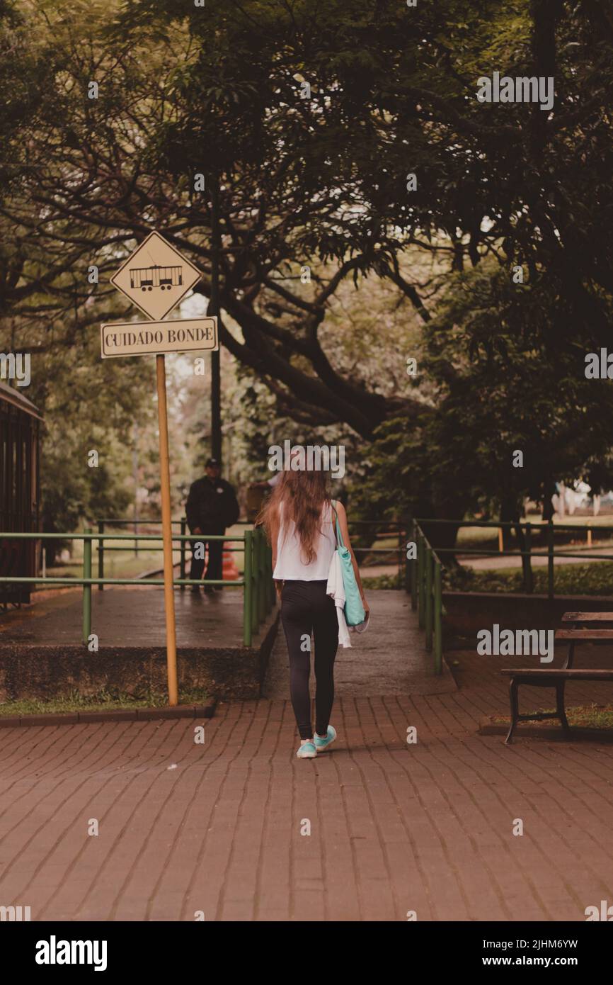 back view of a young woman walking to the train station Stock Photo