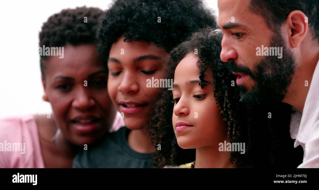 Happy multiracial family using smartphone Stock Photo