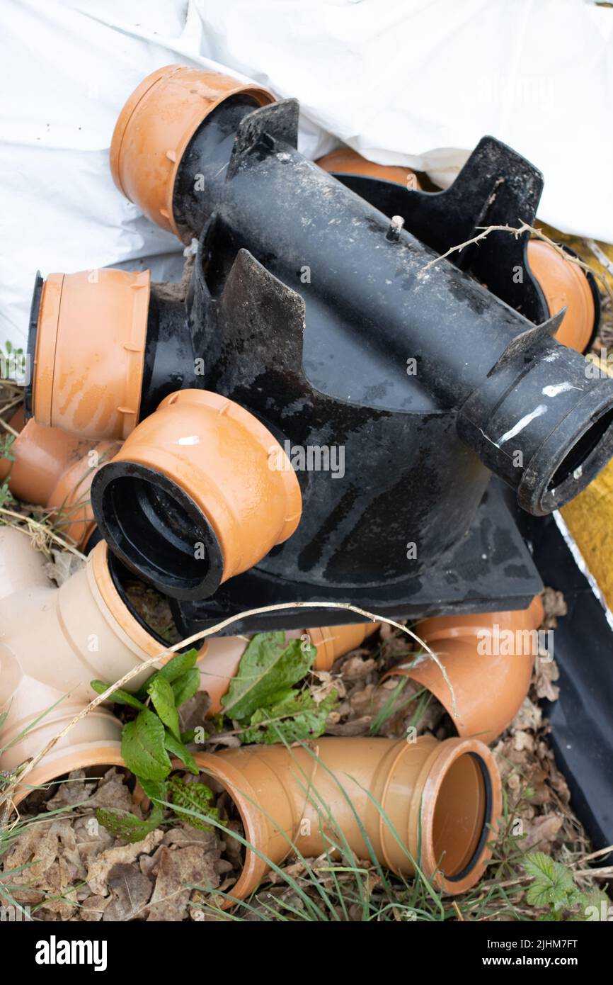 pile of new discarded plastic drainage pipes and joints Stock Photo Alamy