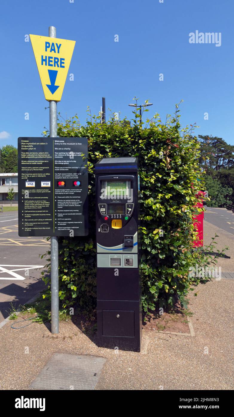 Parking meter explaining the costs of parking and entrance fees at the car park, St Fagans Museum, Cardiff. Summer 2022. July Stock Photo