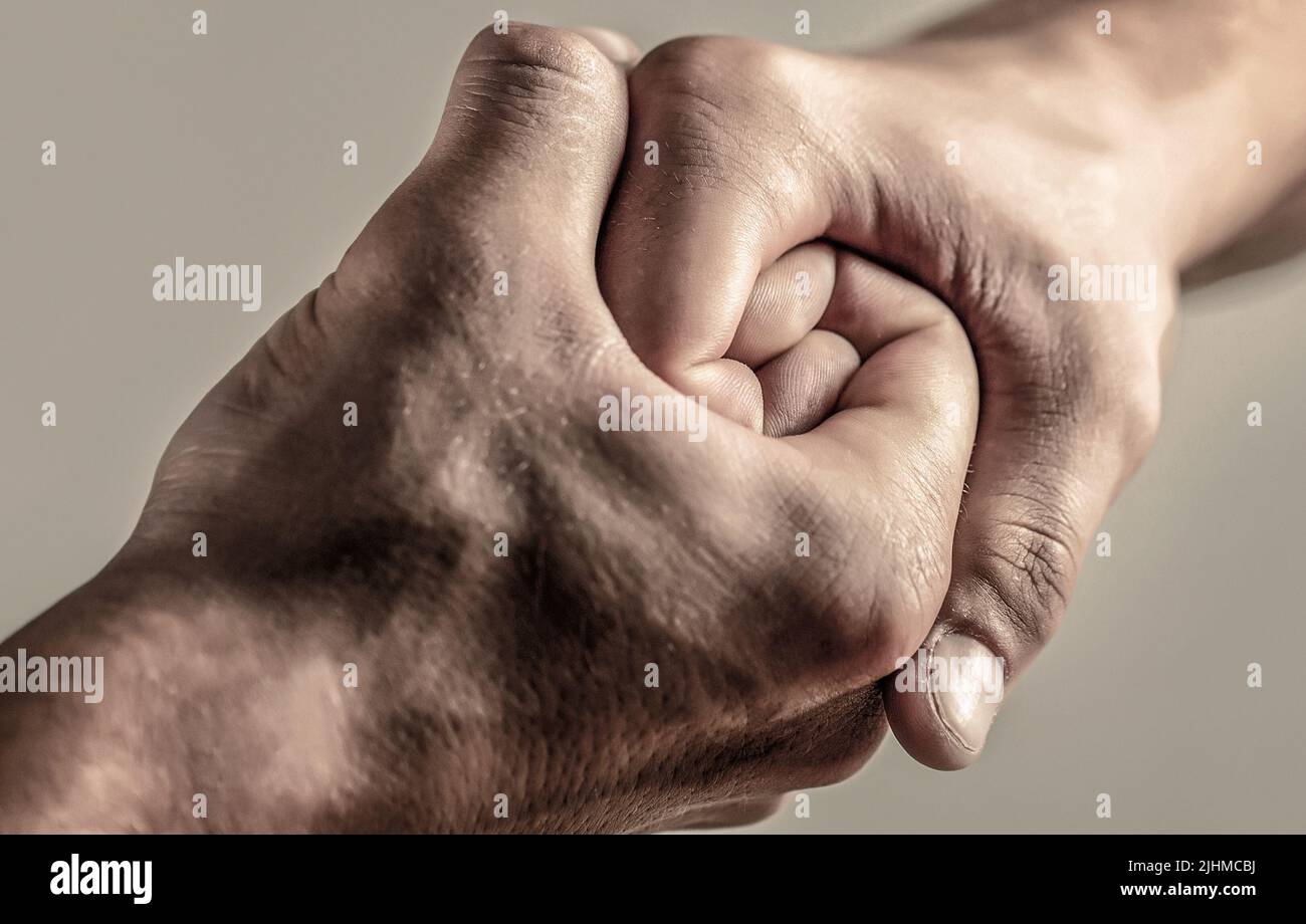 Male hand united in handshake. Man help hands, guardianship, protection