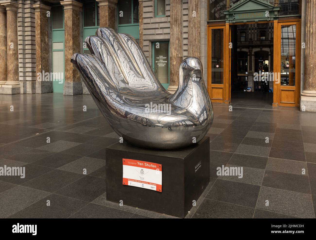 Side view of Hand of peace sculpture by Chinese born artist Yan shufen at Antwerp railway station. The symbol of hand and dove at Antwerp Central Stat Stock Photo