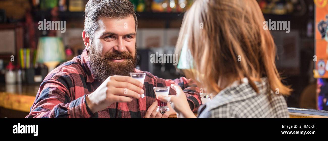 Female male alcoholism. Young man drinking alcohol. Young people at the party drink alcohol. Woman alcoholic beverage in bar. Young woman has problems Stock Photo