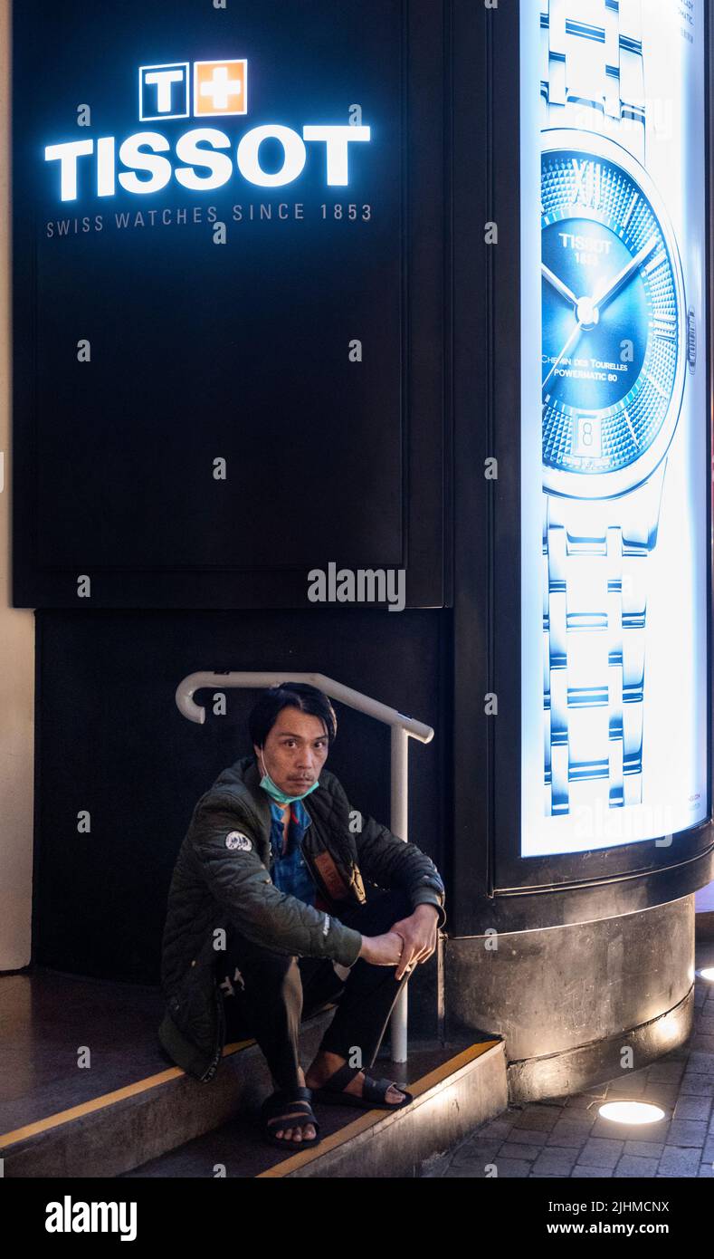 Hong Kong, China. 19th July, 2022. A man sits next to the Swiss watchmaker brand Tissot store in Hong Kong. (Photo by Budrul Chukrut/SOPA Images/Sipa USA) Credit: Sipa USA/Alamy Live News Stock Photo