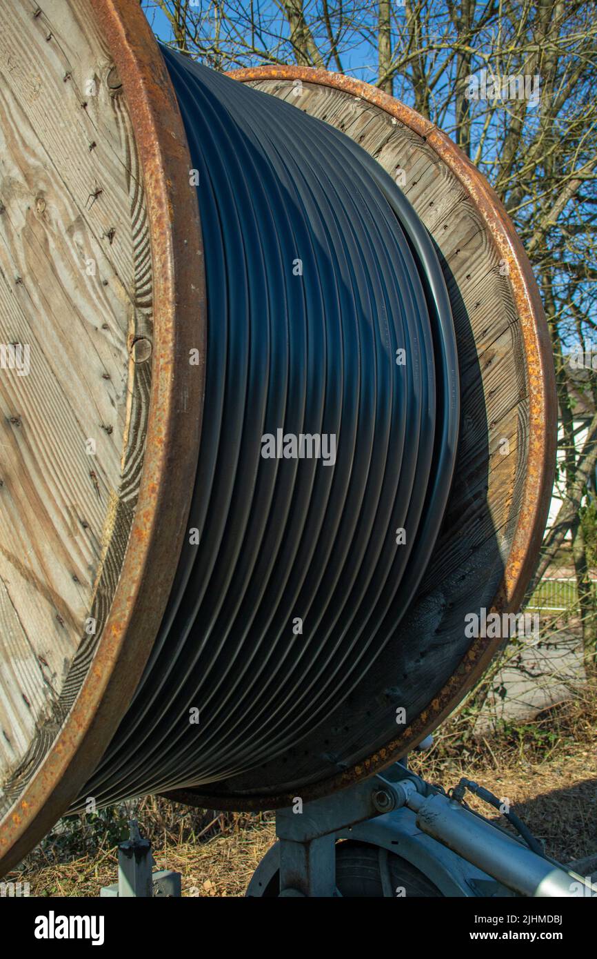 Wooden Cable drum for power cable during road construction in a new development area in Germany Stock Photo