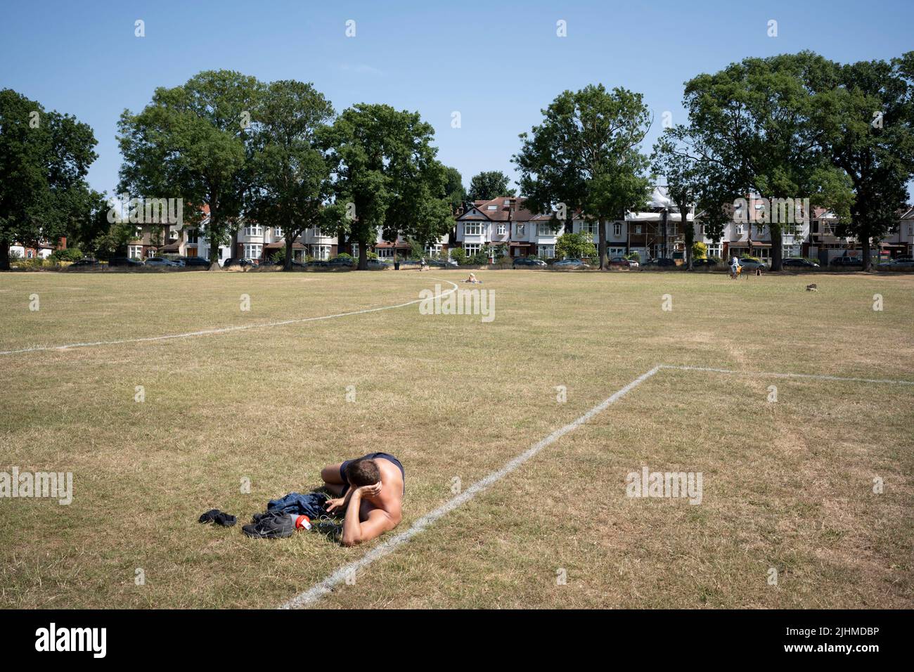 On the day that the UK experienced its highest recorded temperature of 40.3 degrees centigrade (104.5 Fahrenheit), an historical heatwave in Conningsby, Lincolnshire - rail travel was disrupted and major grassland fires broke out, a sunbather enjoys the sun in Ruskin Park, on 19th July 2022, in London, England. The Met Office has in recent days issued  notices to the public - a severe warning of risk to life. Stock Photo