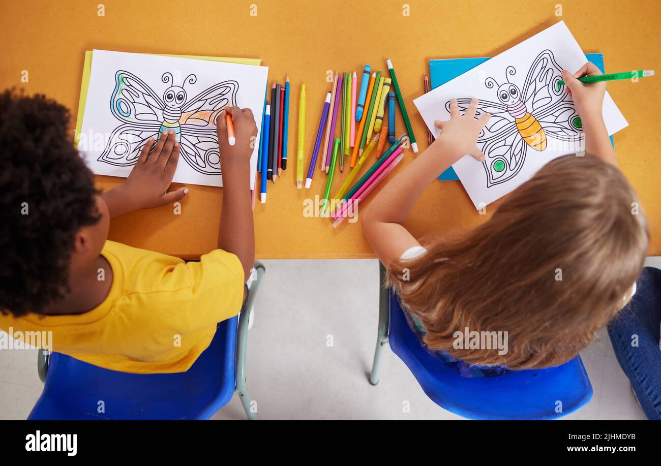 We love colouring. preschool students colouring in class. Stock Photo