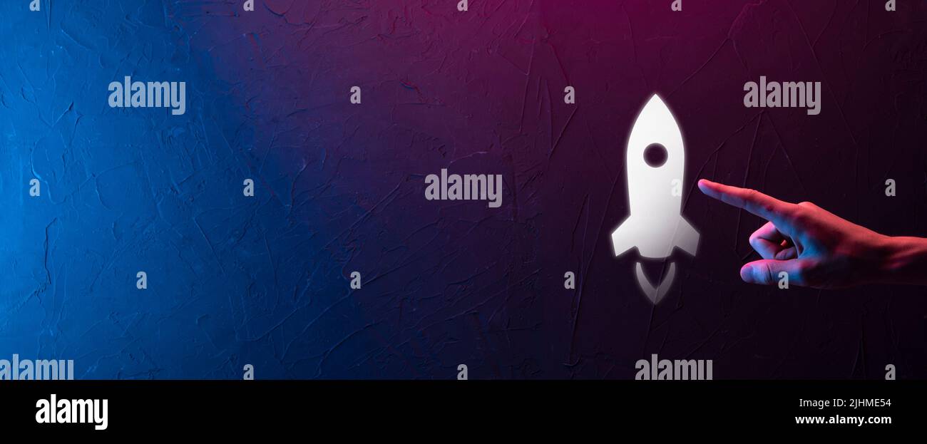 Startup business concept, Businessman holding tablet and icon rocket is ...