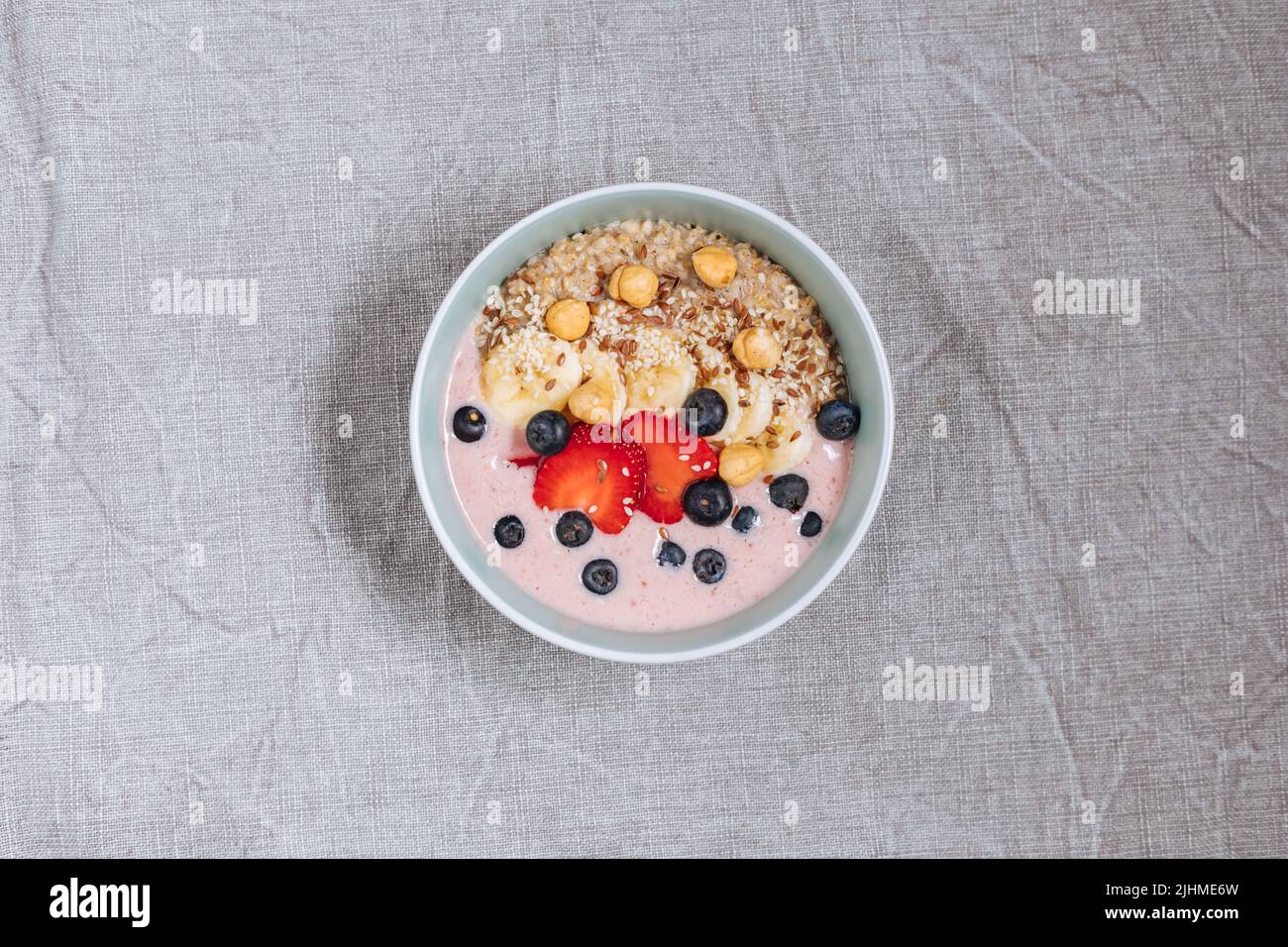 Healthy oatmeal with yoghurt, blueberries, strawberries, banana and