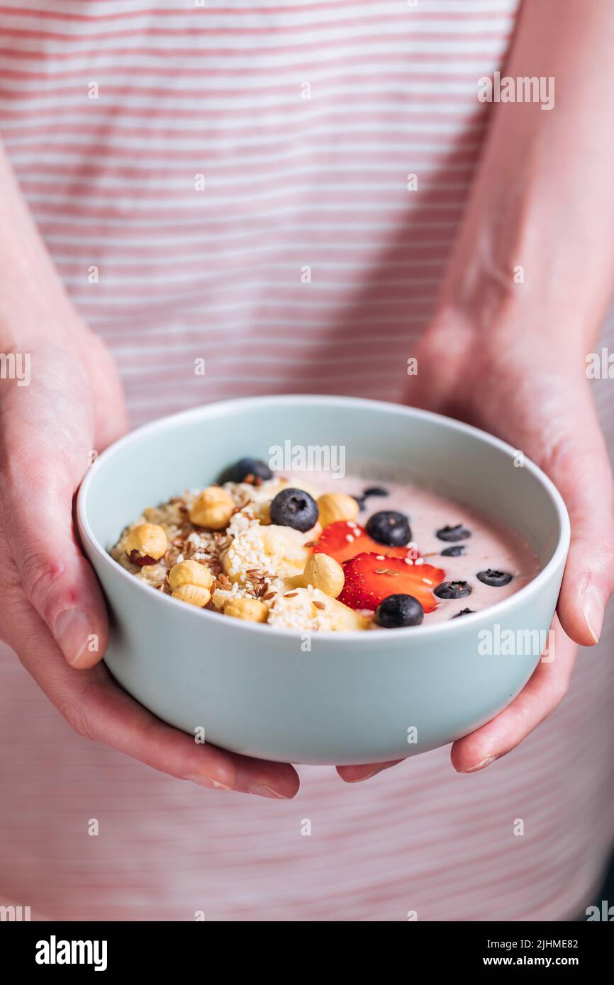 Healthy oatmeal with yoghurt, blueberries, strawberries, banana and