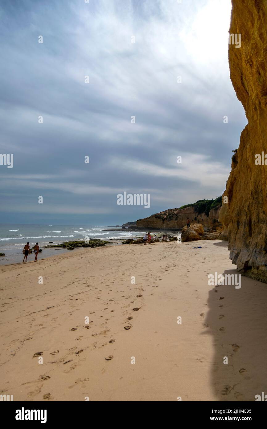 Best beach photography capture, cliffs, ocean, beach sand and people on the beach.Touristic places with beach activities.Algarve destination, summer. Stock Photo