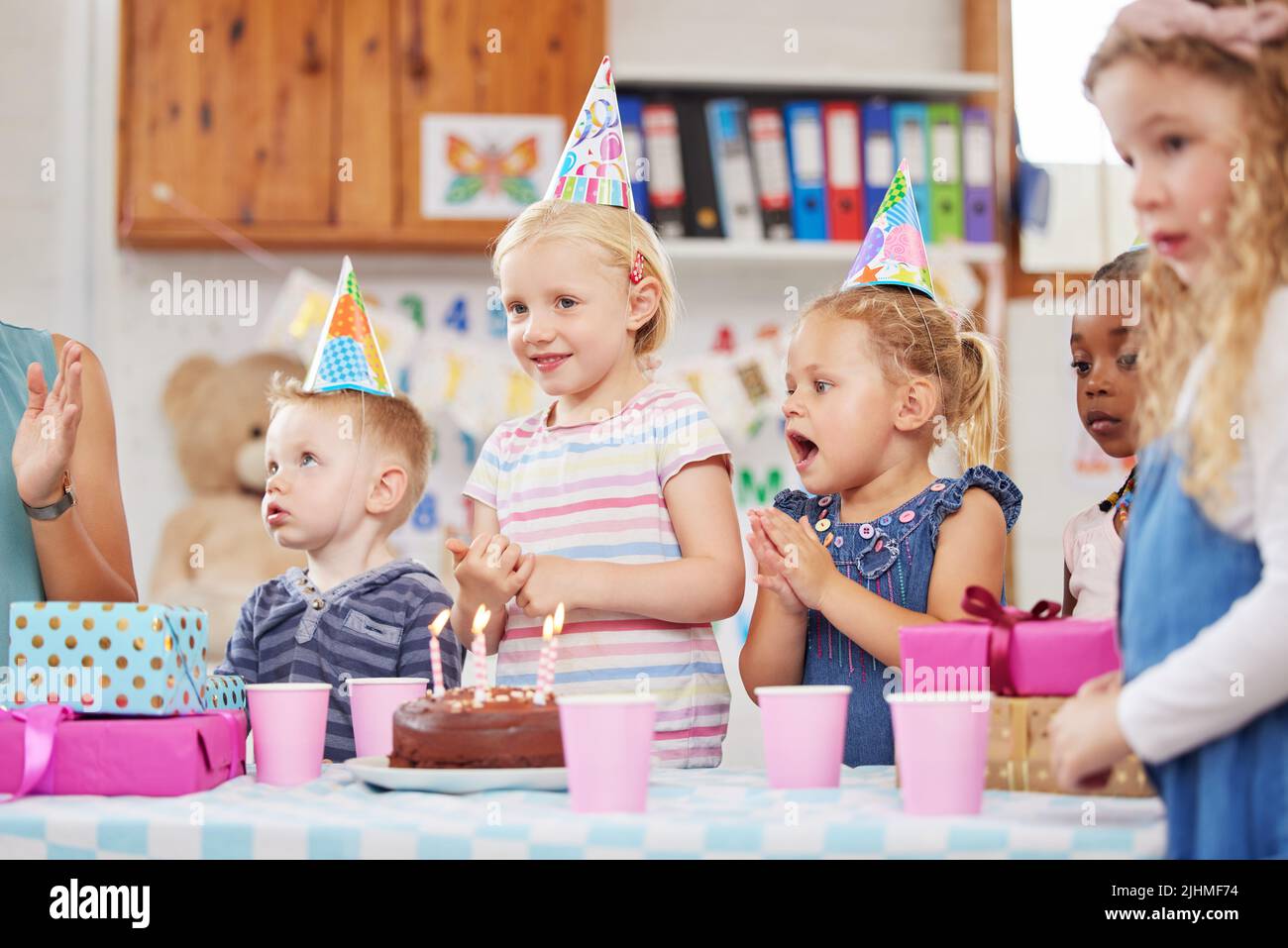 Everyone loves class parties. a preschool children celebrating a birthday in class. Stock Photo