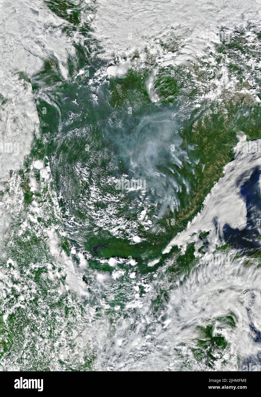 A satellite image showing smoke from wildfires burning in Yakutia Oblast in the Russian far east picked up by the NASA-NOAA Suomi NPP satellite, July 4, 2022, in Earth Orbit. Stock Photo
