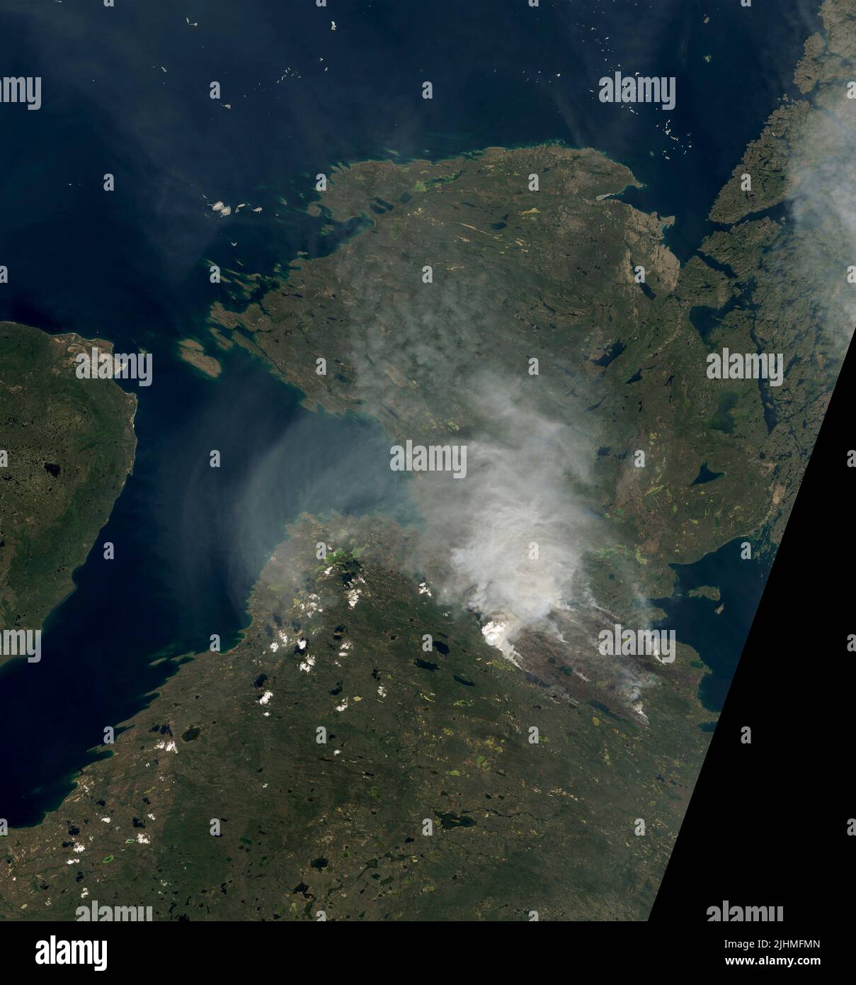 A satellite image showing smoke from wildfires burning near Great Bear Lake in the Northwest Territories of Canada, detected by the NASA Landsat 8 Satellite, July 6, 2022, in Earth Orbit. According to the Canadian government, 136 fires were burning in the Yukon and 65 in the Northwest Territories. Stock Photo