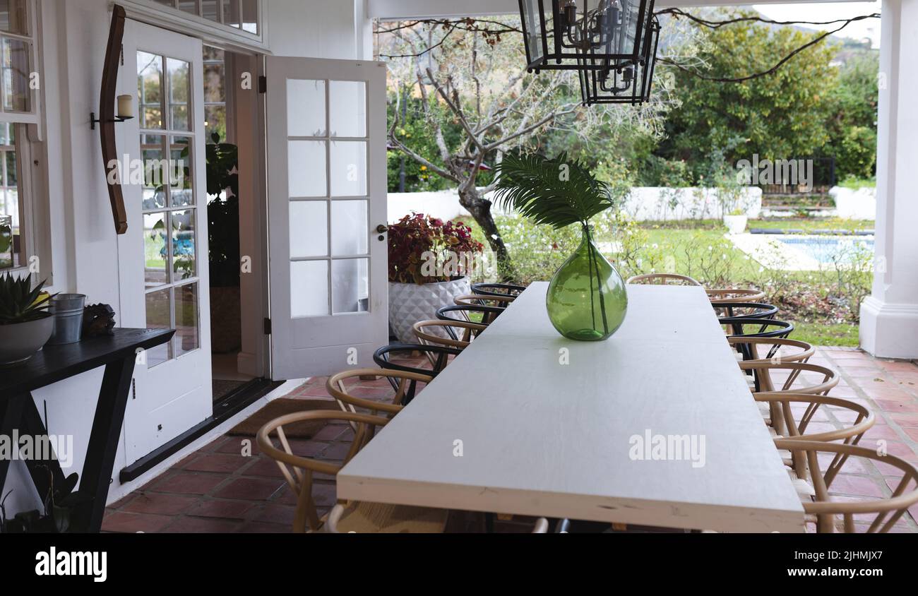 Image of patio with empty dining table and chairs Stock Photo - Alamy