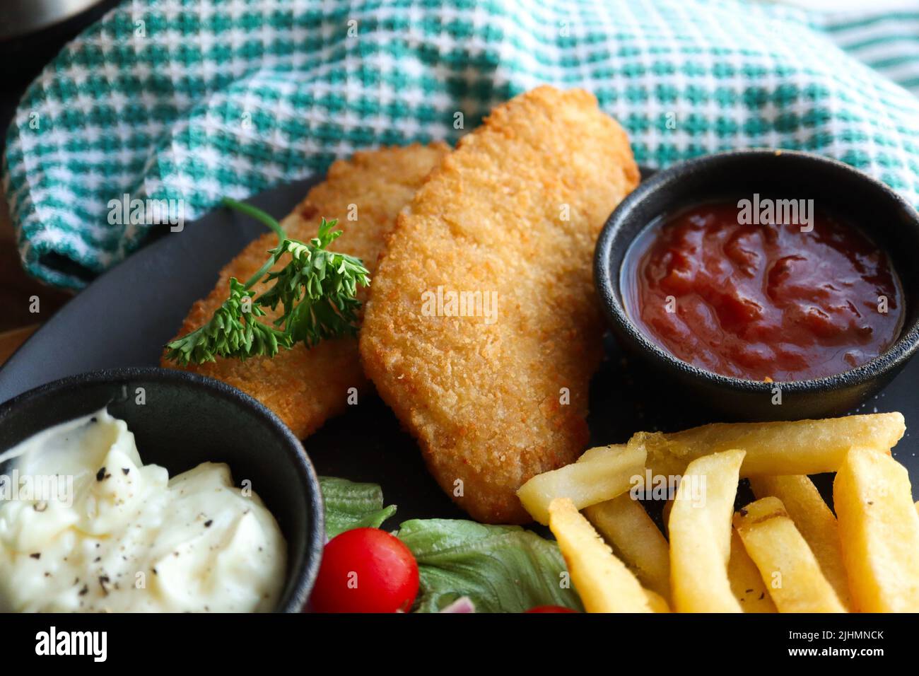 Crispy hake fillets with chips, tomato sauce and tartare sauce Stock